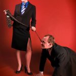 A matriarchal woman and a man on a leash